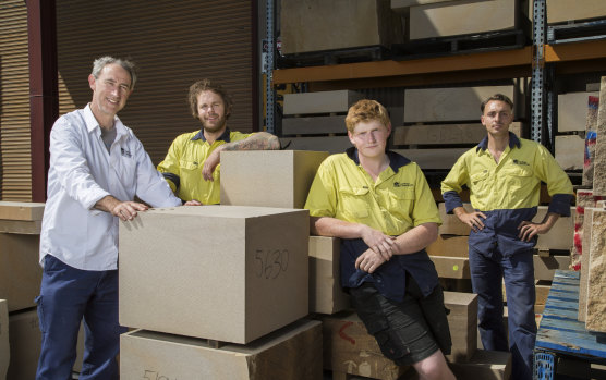 NSW chief stonemason Paul Thurloe, left, with some of the sandstone blocks worked on by second-year apprentice Josiah Gowans and first-year apprentices Michael Butler and Nick Diakos. 