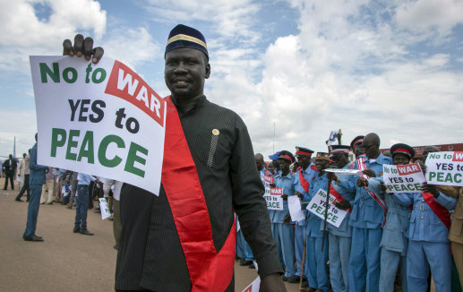 South Sudanese people hold peace signs as talks to end the five-year civil war got under way in June.