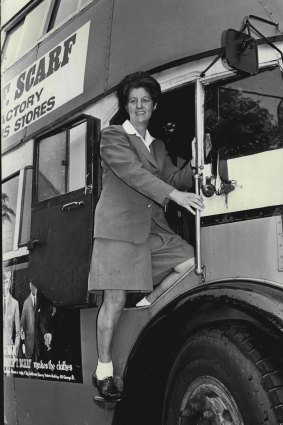 June Lusk climbs into the driver's cabin of a double-decker bus for a driving lesson in 1970.