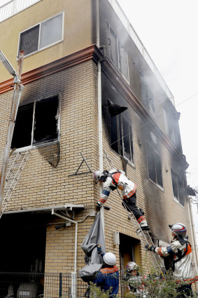 Firefighters work on the scene of the fire at the Kyoto Animation studio on Thursday.