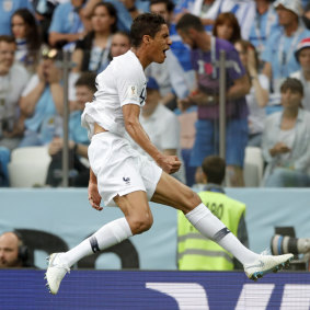 France's Raphael Varane, left, celebrates after scoring his side's opening goal against Uruguay.