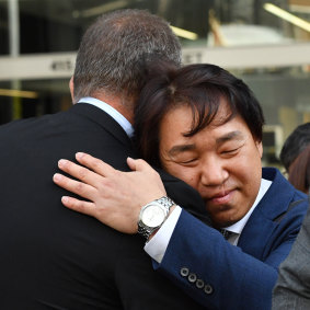 Hyeong-Gyu Ban, the father of Eunji Ban, hugging Detective Sergeant Michael Hall from the Queensland Police outside the Supreme Court in Brisbane on Thursday.