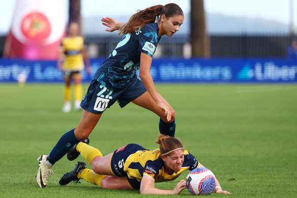 Sydney FC’s star teen Indiana Dos Santos keeps her feet against the Mariners’ Annabel Martin.