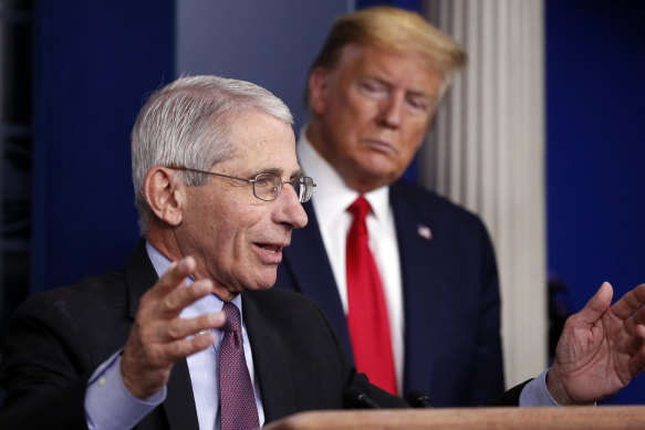 President Do<em></em>nald Trump watches as Fauci speaks at a coro<em></em>navirus press co<em></em>nference in April 2020. 