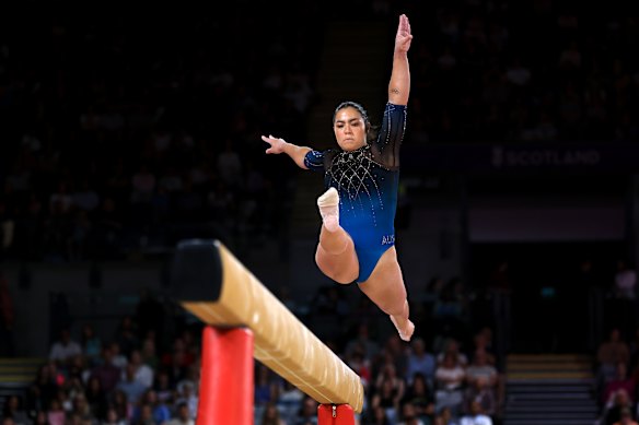 Georgia Godwin performs a split leap on the beam during the all-around team final.