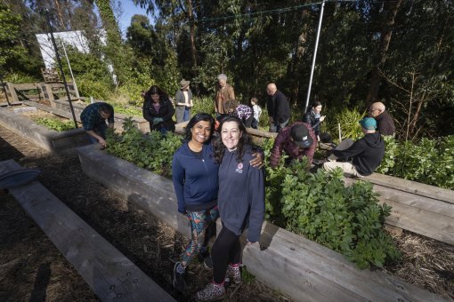 Friends who dig this place: Belgrave Food Garden volunteers Chethi Abayawardana (left) and Ellie McSheedy.
