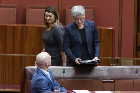 Greens senator Sarah Hanson-Young walks past independent senator David Pocock and Foreign Minister Penny Wong in the Senate on Thursday.