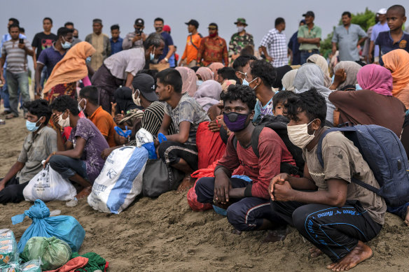 Ethnic Rohingya people take a break after arriving by boat on Lancok Beach, North Aceh, Indonesia, on June 25.