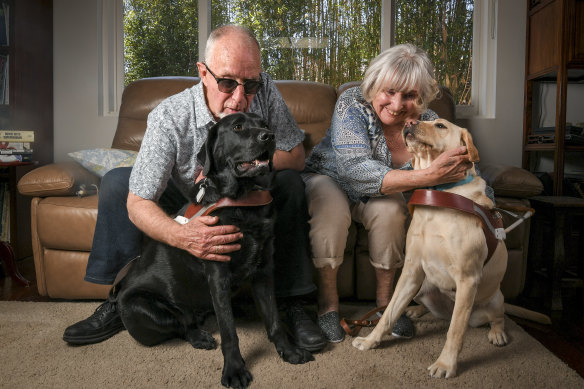 Pete and Pearl Sumner with their guide dogs Kobie (the black one) and Gracie.