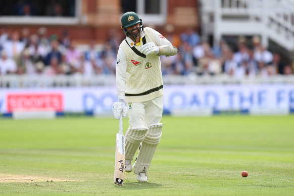 Nathan Lyon, clearly in pain after tearing a calf muscle, attempts to run for a single.