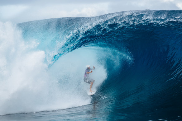 Owen Wright, surfing in a helmet, charges through a barrel on his way to a 2019 Teahupo’o triumph at the famed Tahitian break.