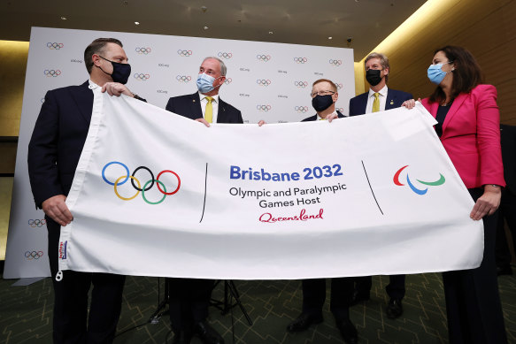 Lord mayor Adrian Schrinner – pictured with federal Sports Minister Richard Colbeck, AOC president John Coates, Olympian James Tomkins and Premier Annastacia Palaszczuk – with a flag that was incorporated into the signature blocks of several Brisbane councillors. 