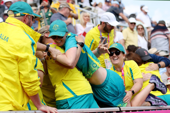 Ellen Ryan is lifted into the stands after the pairs win.