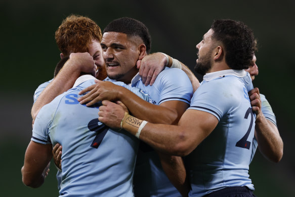 Waratahs players celebrate their win against the Crusaders in Melbourne.
