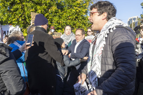 Protesters jostling with Labor Party members attempting to enter the state conference.