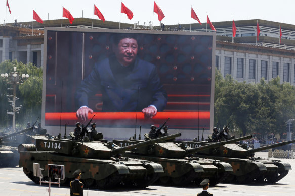 Chinese President Xi Jinping is displayed on a screen as Chinese battle tanks take part in a parade commemorating the 70th anniversary of Japan's surrender during World War II held in front of Tiananmen Gate in Beijing. 