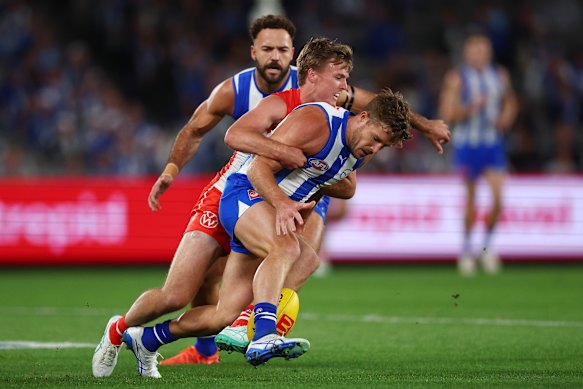Luke Parker of the Kangaroos is tackled.