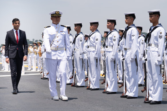 British Prime Minister Rishi Sunak inspects a guard of honour onboard the Japanese aircraft carrier JS Izumo at Yokosuka Naval Base on Thursday, ahead of the G7 Summit in Hiroshima.