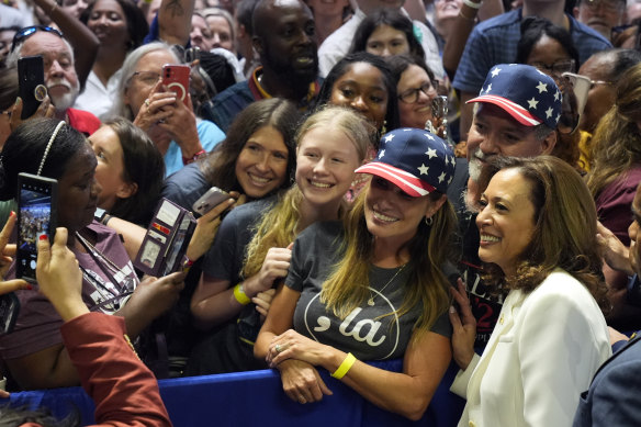 Democratic presidential nominee Vice President Kamala Harris poses for photos at a campaign rally in Savannah, Georgia.