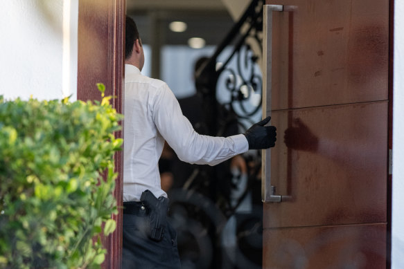 Detectives at a home in Greenacre on Wednesday.