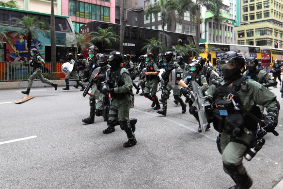 Riot police charge at demonstrators in Hong Kong last year.