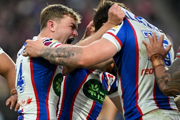 Harrison Graham celebrates with teammates after Newcastle upset Penrith.