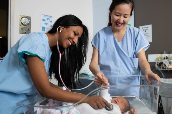Obstetricians Kaushi Arulpragasam and Stephanie Sii with baby Richie Hicks.