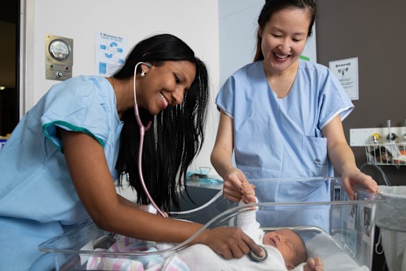 Obstetricians Kaushi Arulpragasam (left) and Stephanie Sii with baby Richie Hicks at the Royal Hospital for Women in Sydney in 2021.