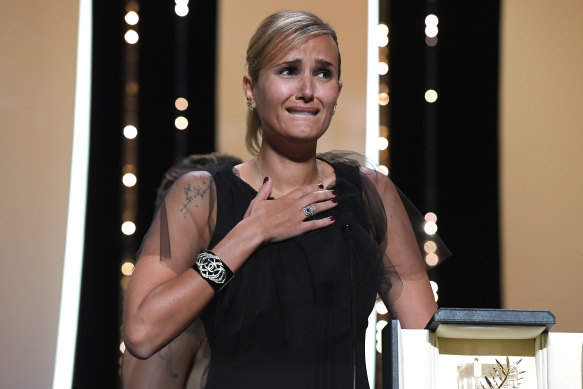 French film director Julia Ducournau is overwhelmed when she wins the Palme d’Or for Titane at the 2021 Cannes Film Festival.