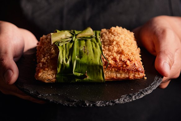 Hotel Canberra’s Stables Cafe & Bar lechon paksiw pie topped with pork crackling crumble and wrapped in banana leaf.
