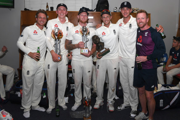 Members of the England team along with one of their coaches, Paul Collingwood, celebrate after winning the last Test.