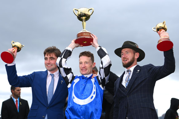 Trainers David Eustace (left) and Ciaron Maher celebrate with jockey Mark Zahra.