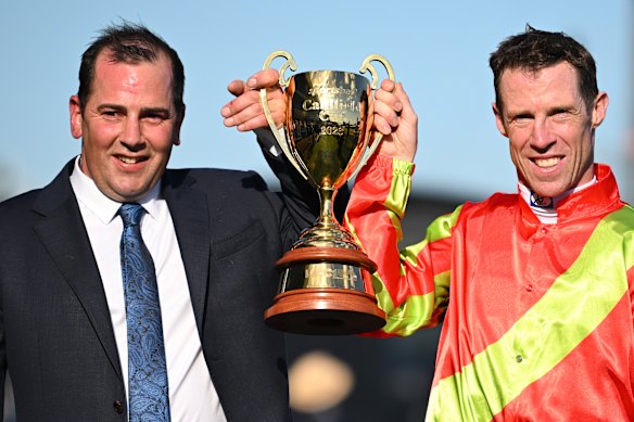 Trainer Gavin Bedggood and jockey John Allen with the Caulfield Cup trophy.