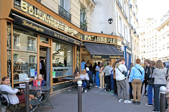 Visitors queue at a patisserie in Paris featured on the Netflix series Emily in Paris.