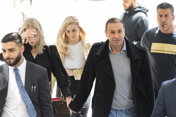 Marwan Haddad and Catherine Le Brocq arrive at Downing Centre court flanked by supporters.  