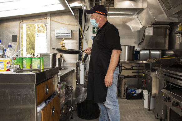 Local chef Sam cooks up breakfast for the police officers at Cann River.