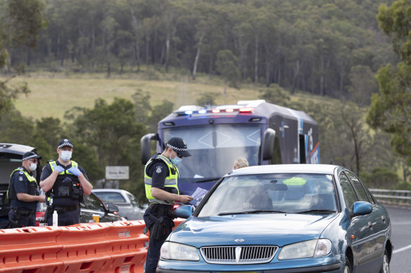 Victoria Police check for permits at a road block at Genoa on the Victorian border.
