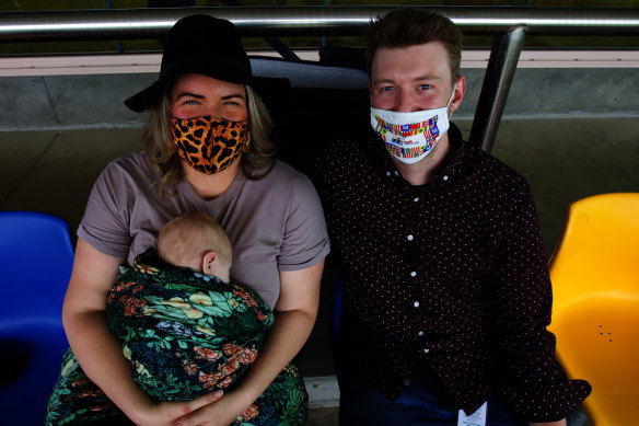 Sarah McKenzie and Matthew Bourke with their baby Finley Bourke in the grandstand.