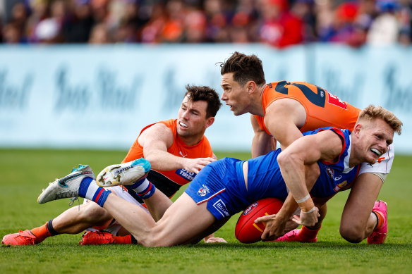 Bulldog Adam Treloar is gang-tackled by Giants Josh Kelly and Brent Daniels at Ballarat on Saturday.