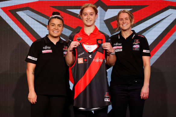 New Bomber Amber Clarke (centre) with Maddy Prespakis and coach Lauren Wood.