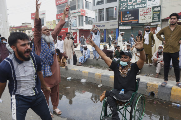 Supporters of Tehreek Labbaik Pakistan block a road and shout slogans protesting the arrest of their party leader Saad Rizvi in Lahore on Sunday.