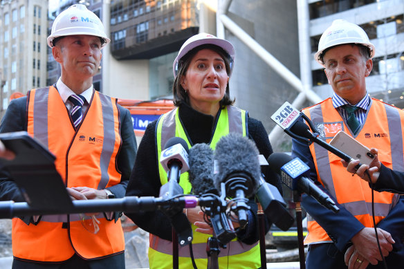 NSW Premier Gladys Berejiklian, flanked by Planning Minister Rob Stokes, left, and Transport Minister Andrew Constance, at the site of the new underground metro train station at Martin Place in Sydney on Wednesday.


