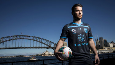Pride in the jersey: Alex Baumjohann models Sydney FC's new charcoal strip.