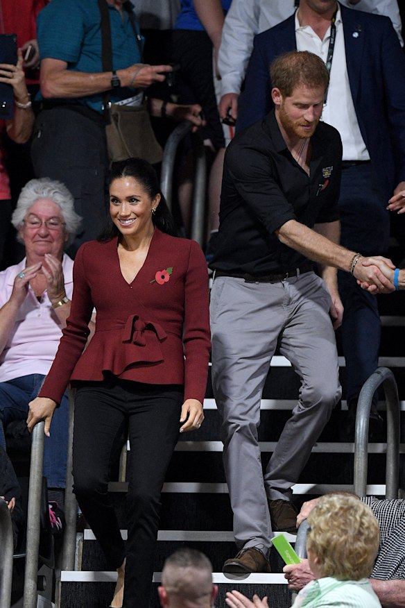 The royals shook hands as they arrived at the game.