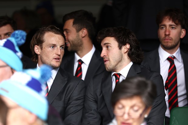 Essendon players Mason Redman and captain Andrew McGrath at the state funeral. 