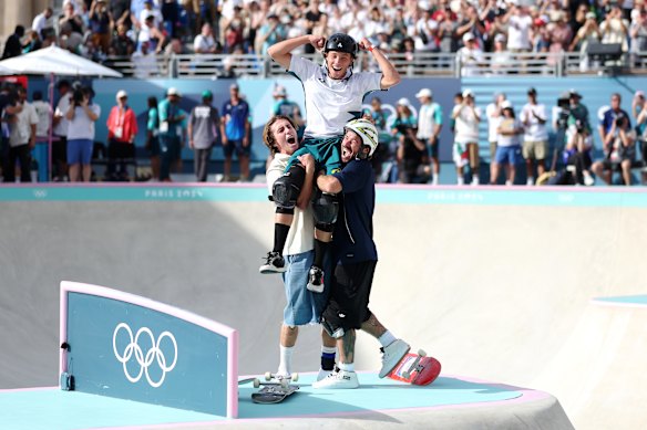 Gold medallist Keegan Palmer of  Australia, centre, celebrates with Tate Carew of the United States, left, and Pedro Barros of Brazil after the men’s park final.