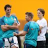 Pat Cummins and David Warner speak to Australian Formula 1 driver Oscar Piastri during an Australia Training Session at Lord’s Cricket Ground in 2023.