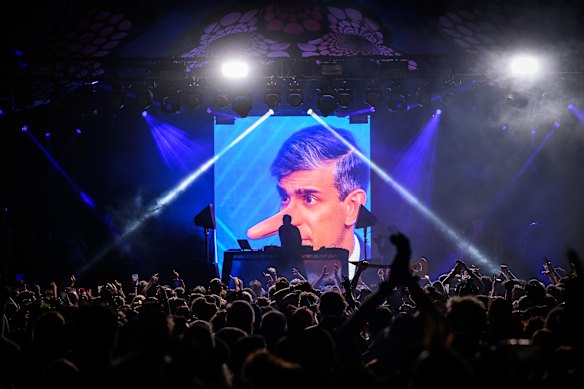 A satirical representation of British Prime Minister Rishi Sunak with a Pinocchio-style extended nose is displayed at the end of a DJ set by British artist Fatboy Slim on the Glade State in the early hours of day five of Glastonbury Festival 2024.