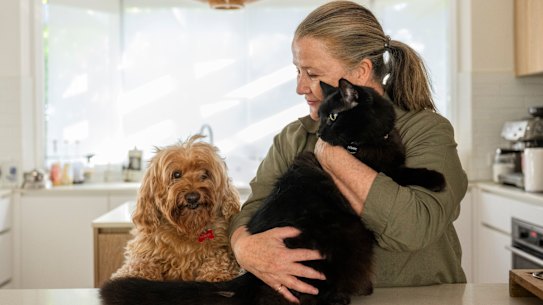 Penny Pedersen with her inside cat Neville and dog, Harvey, at her Ryde home in Sydney.