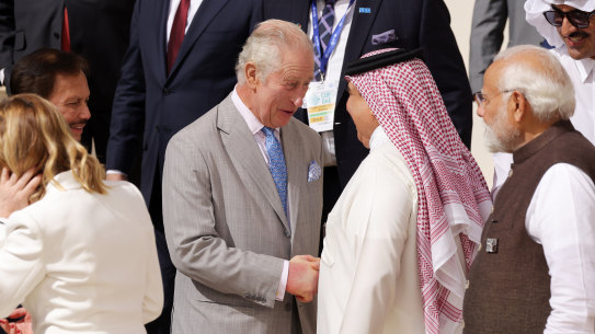 King Charles III greets fellow heads of state as he prepares for a family photo during day one of the COP28 Climate Conference in Dubai.